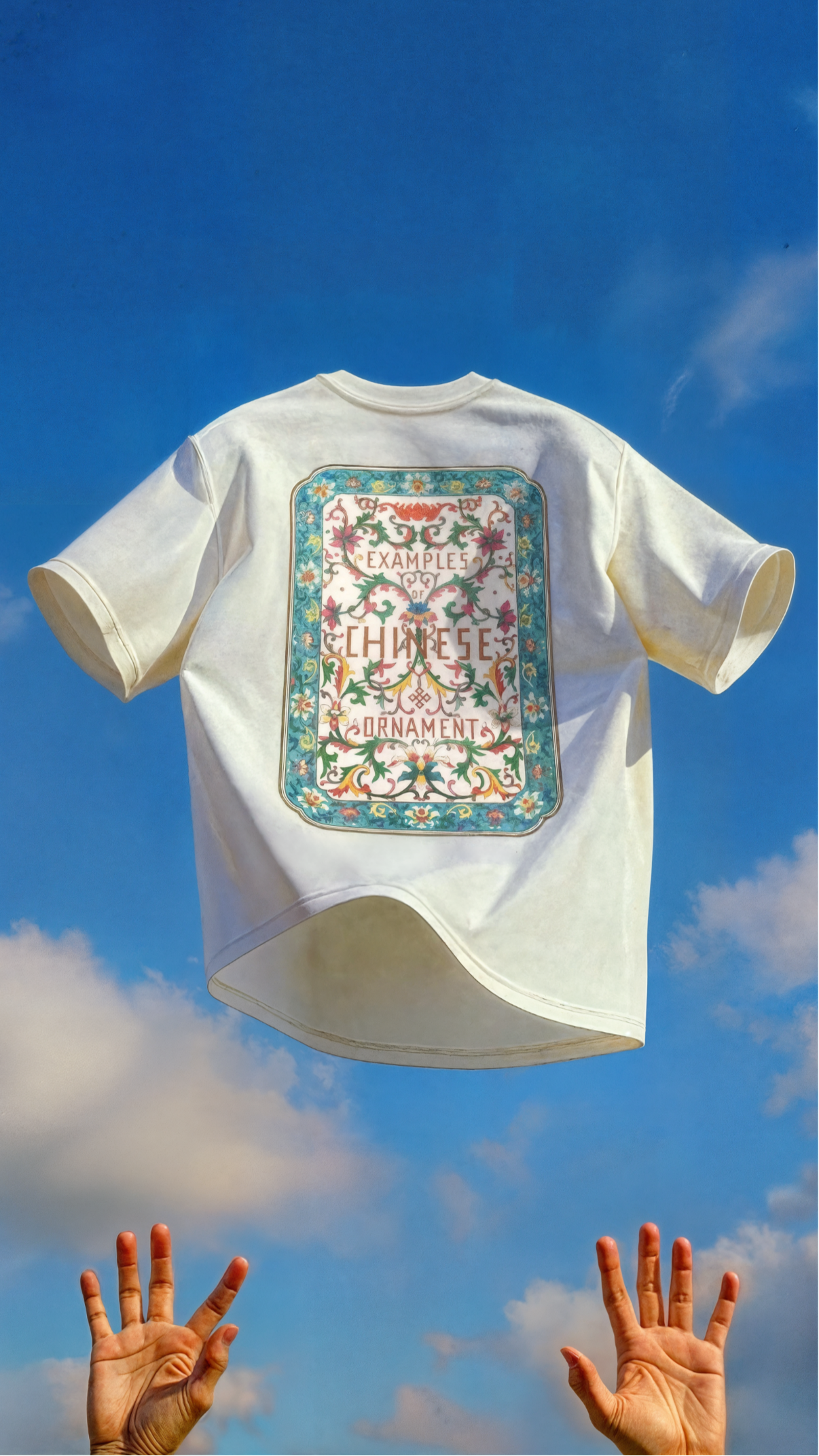 White t-shirt with colorful graphic design on a blue sky background